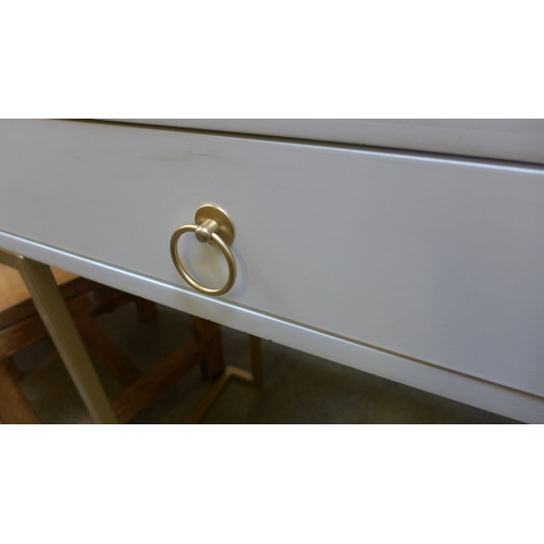 1562 - A white console table with gold legs