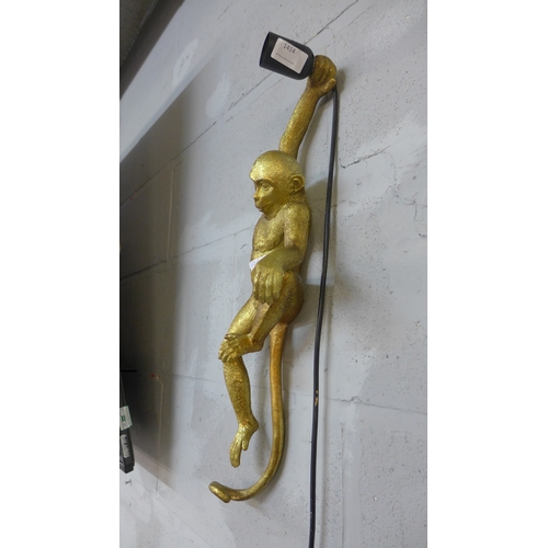 1414 - A wall light in the form of a hanging monkey