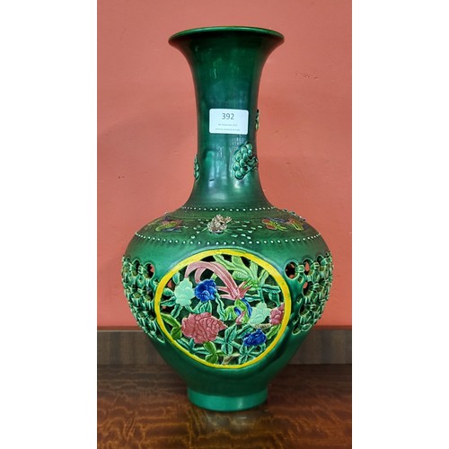 392 - A Chinese green glazed pierced porcelain vase, 36cms h