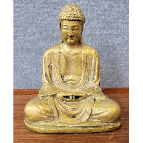 393 - A brass figure of seated Buddha, 26cms h