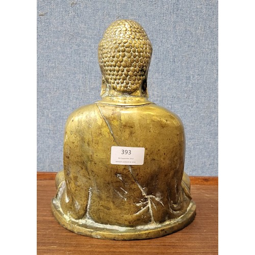 393 - A brass figure of seated Buddha, 26cms h