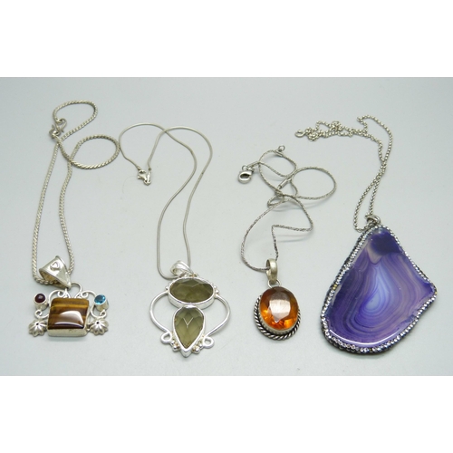 1026 - Four silver pendants and chains