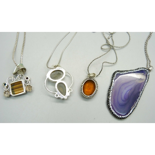 1026 - Four silver pendants and chains