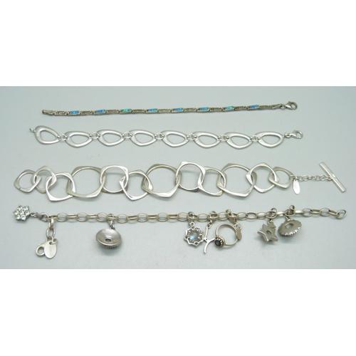 1028 - A silver Milano charm bracelet and three other silver bracelets, 58.4g