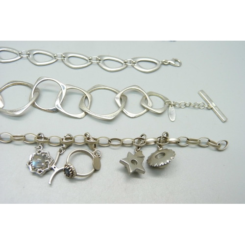 1028 - A silver Milano charm bracelet and three other silver bracelets, 58.4g