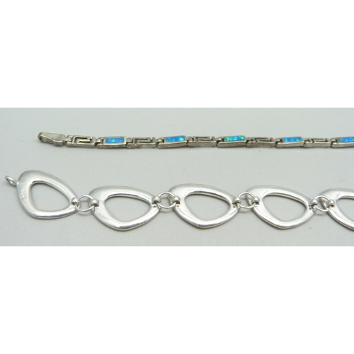 1028 - A silver Milano charm bracelet and three other silver bracelets, 58.4g