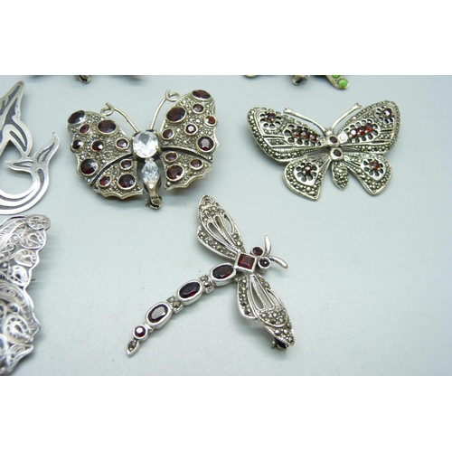 1030 - Nine large silver brooches; seven butterfly, one dragonfly and one whale, three set with garnets and... 