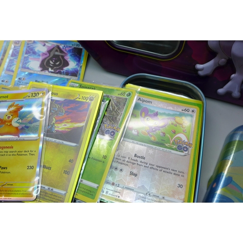 622 - 120 Reverse Holo and Holo Pokemon cards in collectors tin with Pokemon book