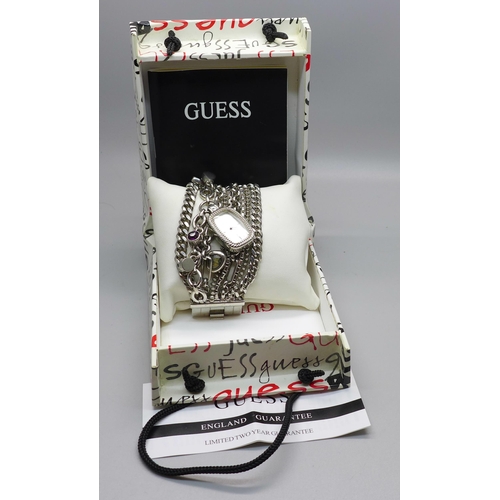 623 - A Guess charm bracelet wristwatch, boxed