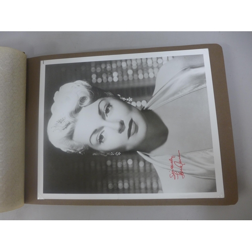 656 - Two albums of 1940s and 1950s movie star and celebrity signed photographs, real and facsimile, one a... 