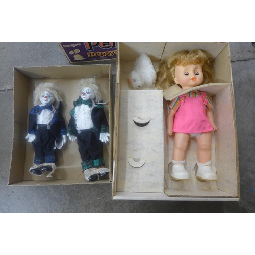 698 - A Penny Puppywalker, boxed and other porcelain dolls