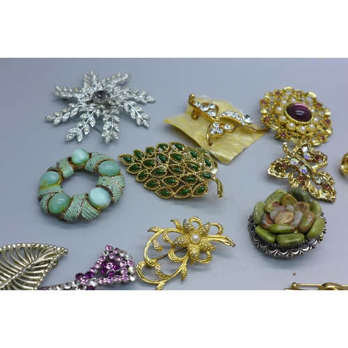 866 - Fifty-six costume brooches