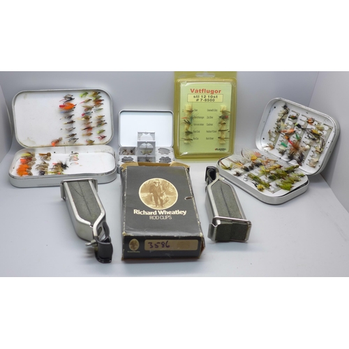 888A - A collection of fishing flies, (2 tins), and rod clips