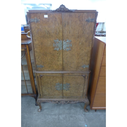 100 - A Queen Anne style figured walnut cocktail cabinet