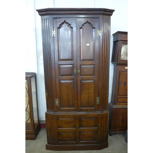 104 - A George III oak architectural freestanding corner cupboard