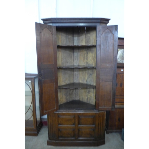 104 - A George III oak architectural freestanding corner cupboard