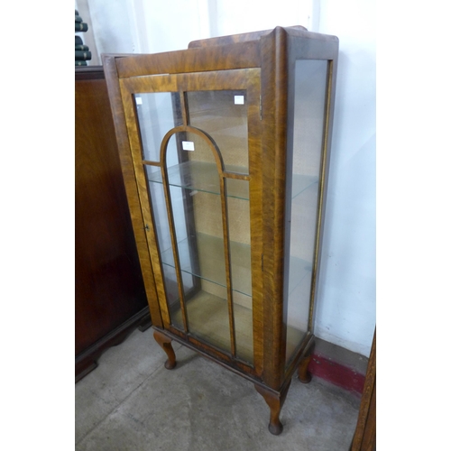 107 - An Art Deco walnut single door display cabinet