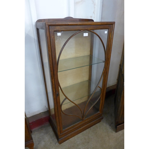 108 - An Art Deco oak single door display cabinet