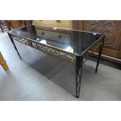 115 - An Italian style cast metal and black glass topped rectangular coffee table, reg. design no. 907897