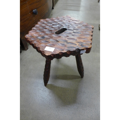 141 - A carved softwood stool