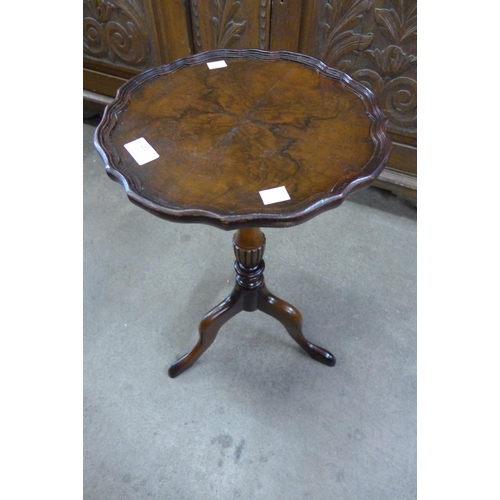 150 - A mahogany and burr walnut tripod wine table