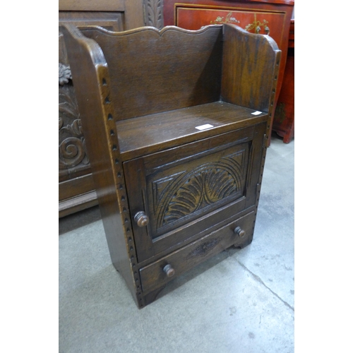 153 - A small 17th Century style carved Ipswich oak single door cupboard