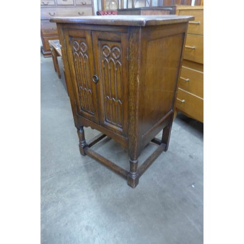 154 - A small 17th Century style carved oak two door cupboard