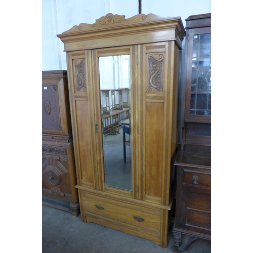 160 - An Edward VII satin birch single door wardrobe