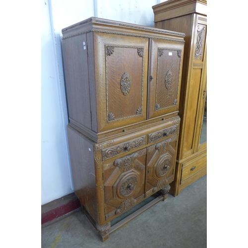 161 - An early 20th Century Jacobean Revival carved oak cocktail cabinet