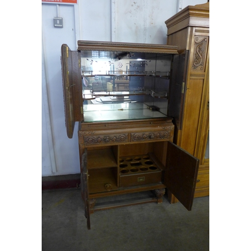 161 - An early 20th Century Jacobean Revival carved oak cocktail cabinet