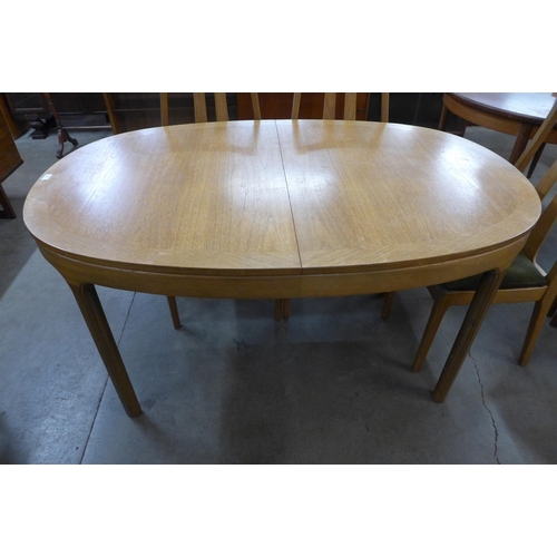 19 - A Nathan teak extending dining table and six chairs