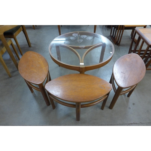 21 - A Nathan Trinity teak and glass topped circular nest of tables