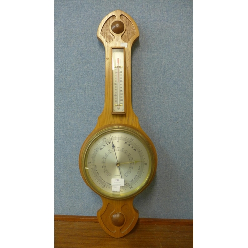 298 - A carved walnut aneroid barometer