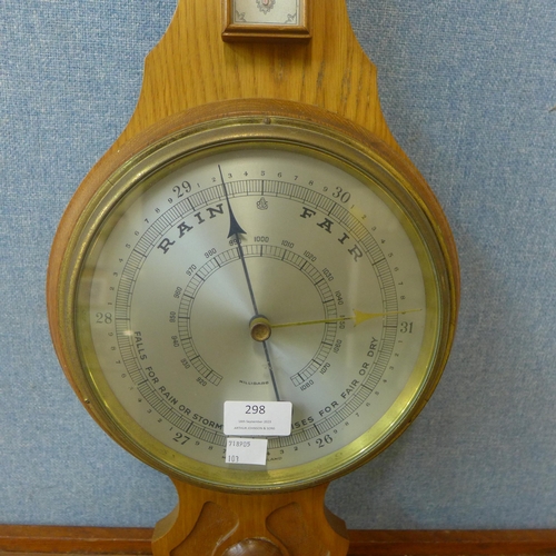 298 - A carved walnut aneroid barometer