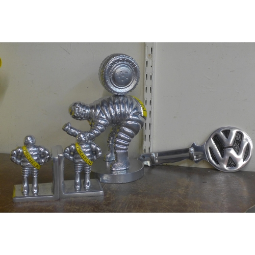 300 - A painted cast iron Michelin Man tyres figure, a pair of book ends and a VW key rack