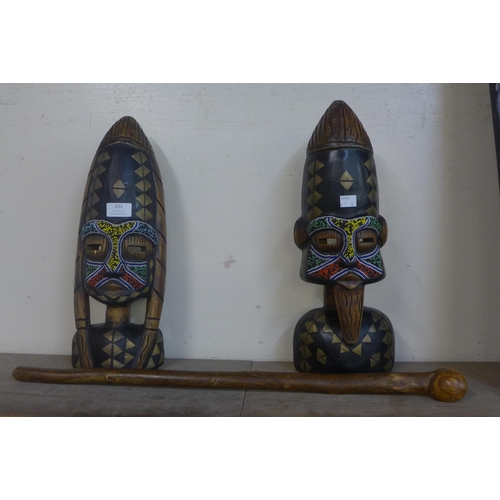 301 - A pair of painted carved wooden African busts and a knobkerrie