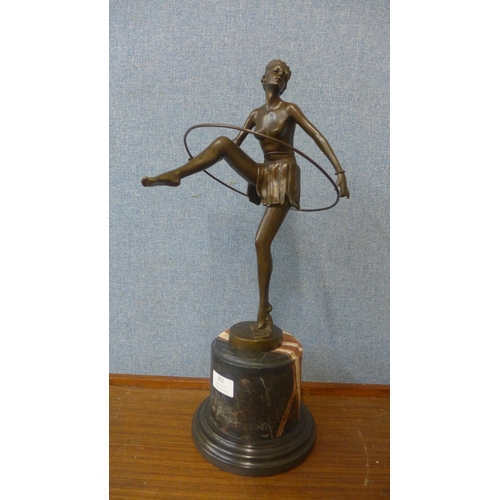 302 - An Art Deco style bronze figure of a dancing hoop girl, on rouge marble socle