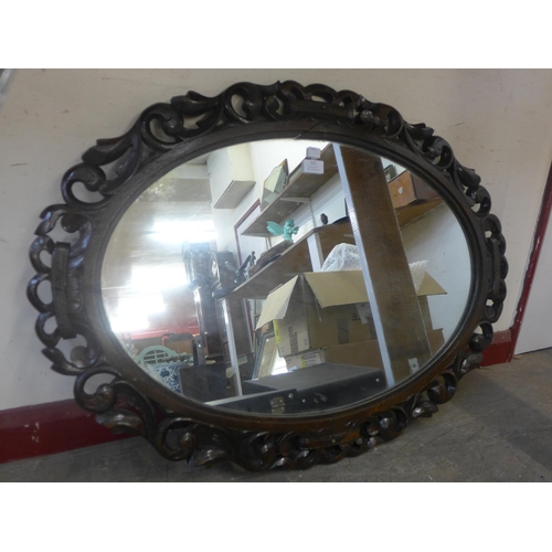 322 - An Edward VII carved oak oval framed mirror