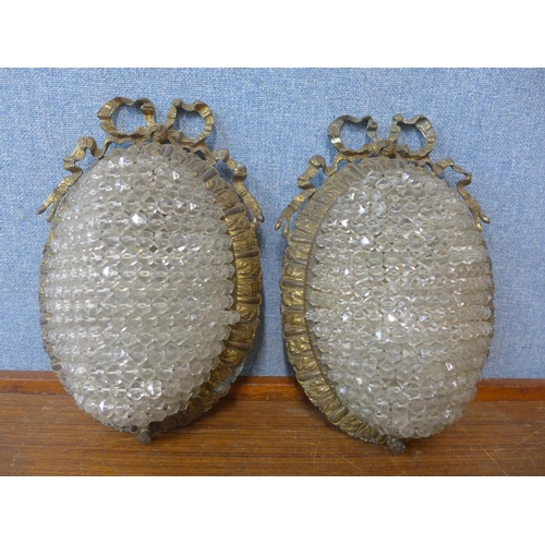 324 - A pair of French rococo style gilt metal and glass wall lights, 26cms h