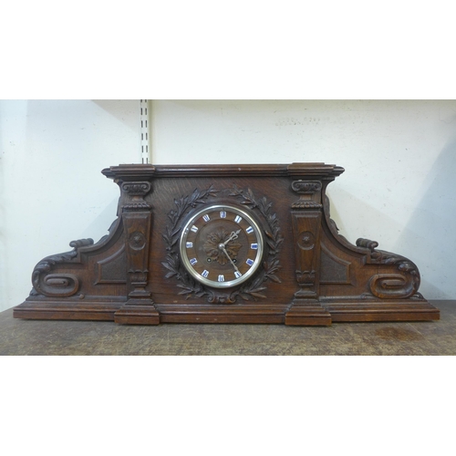 325 - A late 19th Century French carved oak architectural cased mantel clock