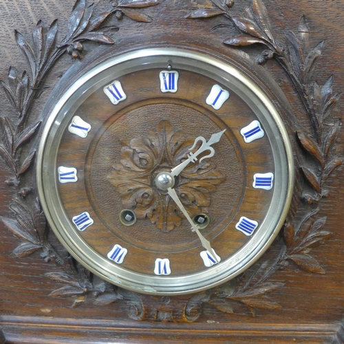 325 - A late 19th Century French carved oak architectural cased mantel clock