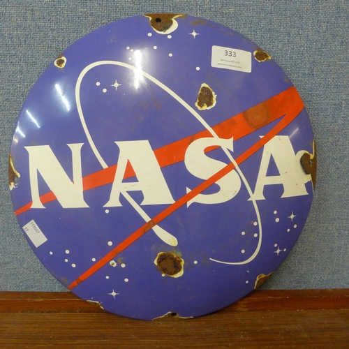 333 - An enamelled circular NASA sign