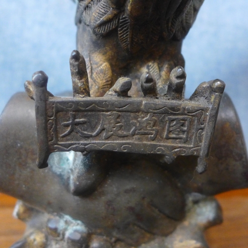 337 - An oriental bronze figure of an eagle