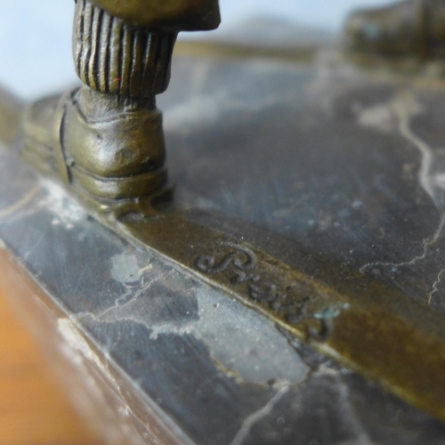 338 - A bronze figure of a young boy on skis, on grey marble socle