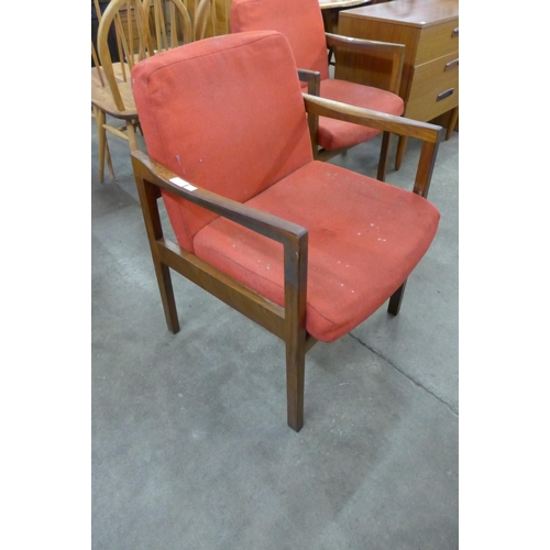 35 - A pair of teak elbow chairs