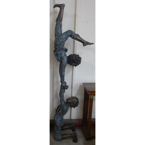 350 - A large bronze sculpture of two boy acrobats