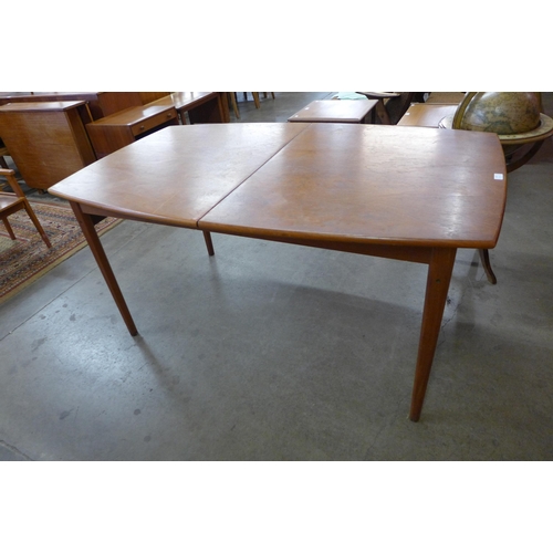 64 - A Danish teak extending dining table