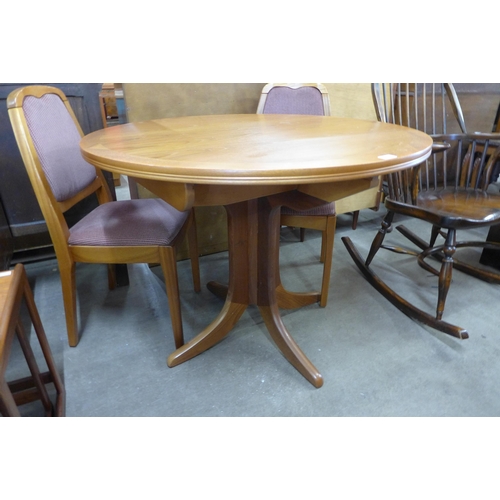 68H - A Nathan teak extending dining table and four chairs