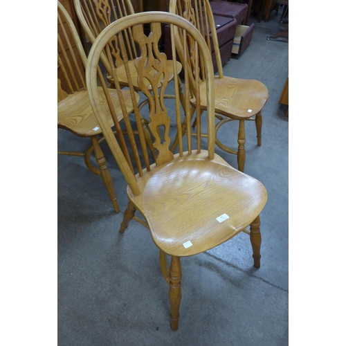 82 - A set of four ash crinoline stretcher Windsor chairs