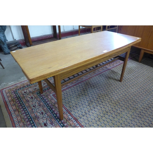 9 - A Danish teak metamorphic dining/coffee table